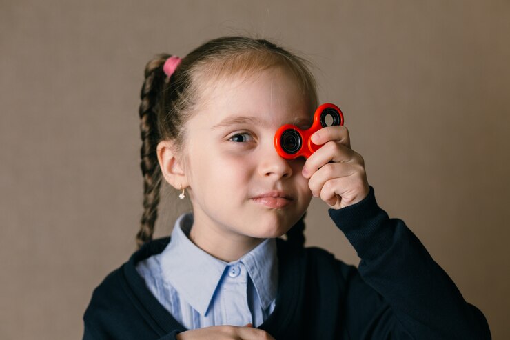 Little girl with fidget spinner held up his eyes 122104 684